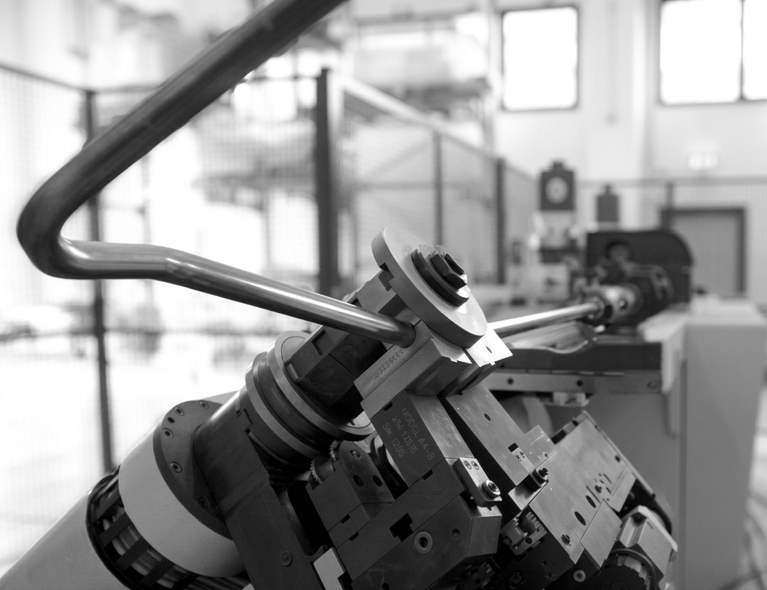 CNC bending machine shaping a steel frame tube